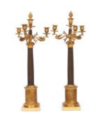 A PAIR OF EMPIRE PERIOD GILT AND PATINATED BRONZE CANDELABRA, EARLY 19TH CENTURY, FRENCH