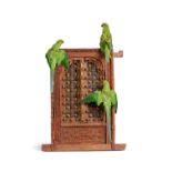 AN ANTIQUE INDIAN WINDOW FEATURING A TRIO OF TAXIDERMY PARAKEETS