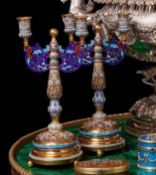 A PAIR OF SILVER GILT AND CHAMPLEVE ENAMEL CANDELABRA IN THE RUSSIAN STYLE