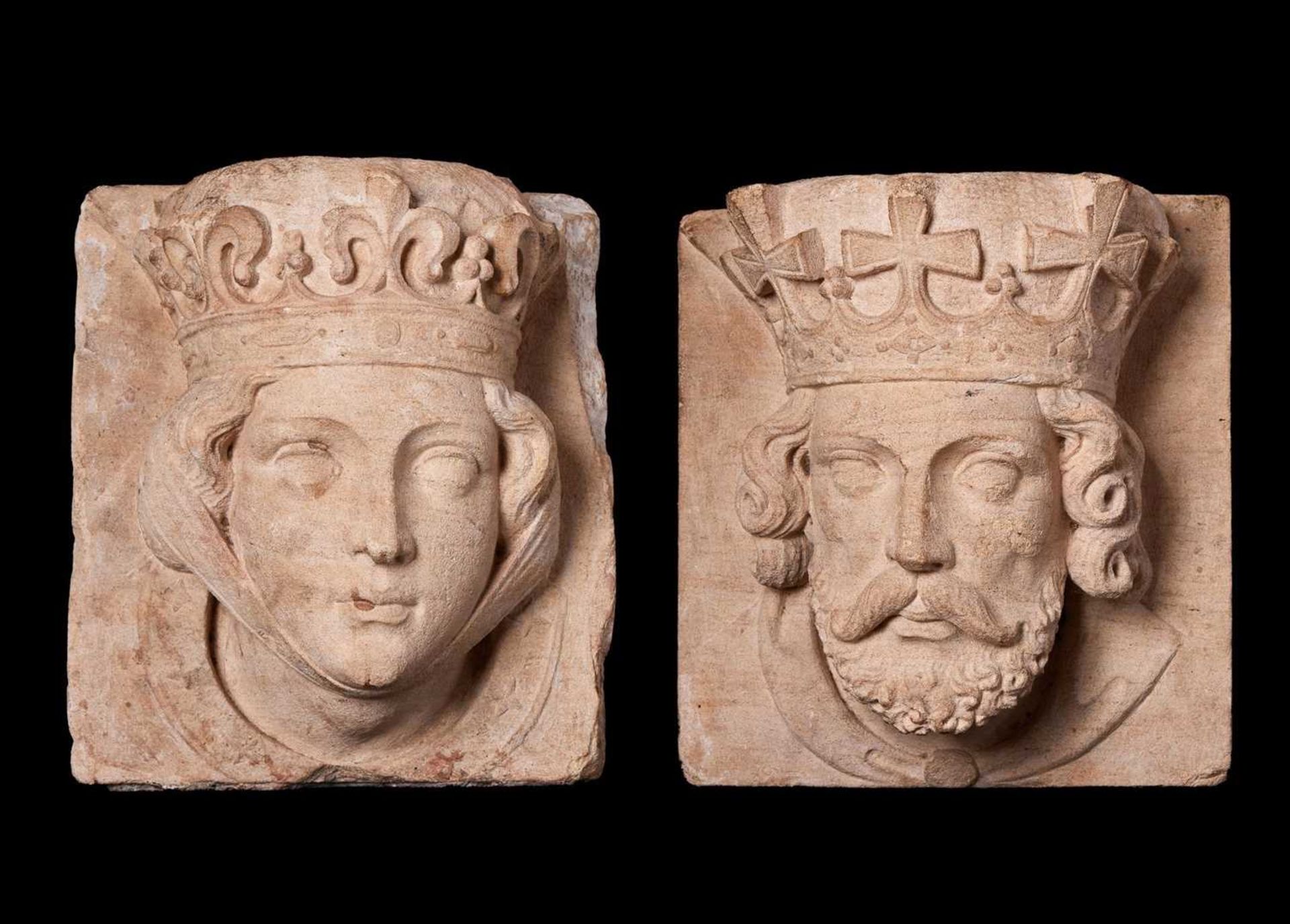A PAIR OF 19TH CENTURY CARVED STONE HEADS OF A KING AND QUEEN