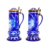 A FINE PAIR OF 19TH CENTURY BOHEMIAN BLUE OVERLAY CUT AND ENGRAVED GLASS TANKARDS