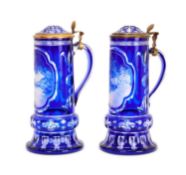 A FINE PAIR OF 19TH CENTURY BOHEMIAN BLUE OVERLAY CUT AND ENGRAVED GLASS TANKARDS