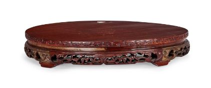 A LARGE CHINESE CARVED HARDWOOD STAND