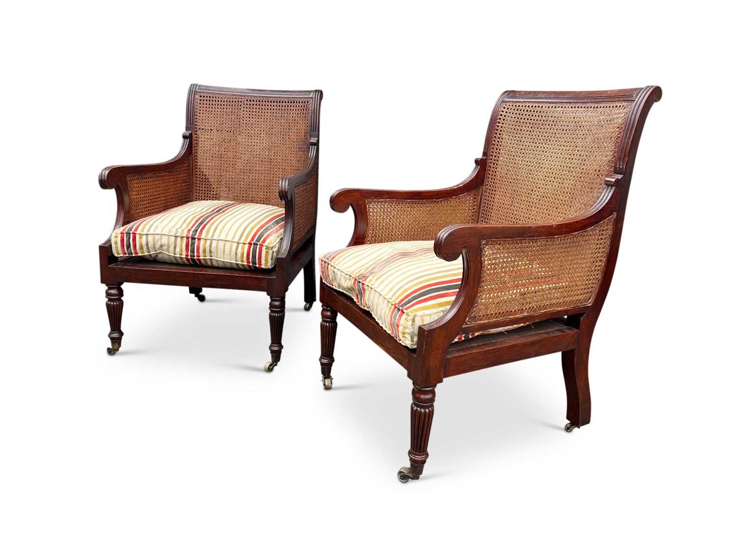 A PAIR OF EARLY 20TH CENTURY CANED BERGERE OR LIBRARY CHAIRS