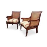 A PAIR OF EARLY 20TH CENTURY CANED BERGERE OR LIBRARY CHAIRS