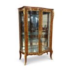 A FINE LATE 19TH CENTURY KINGWOOD AND ORMOLU SERPENTINE VITRINE RETAILED BY JAMES SHOOLBRED