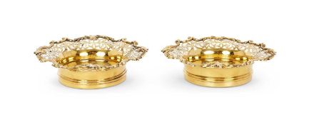 A FINE PAIR OF 19TH CENTURY SILVER AND SILVER GILT WINE COASTERS, LONDON, 1838