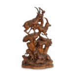 A LARGE LATE 19TH CENTURY BLACK FOREST CARVED LINDENWOOD GROUP OF IBEXES