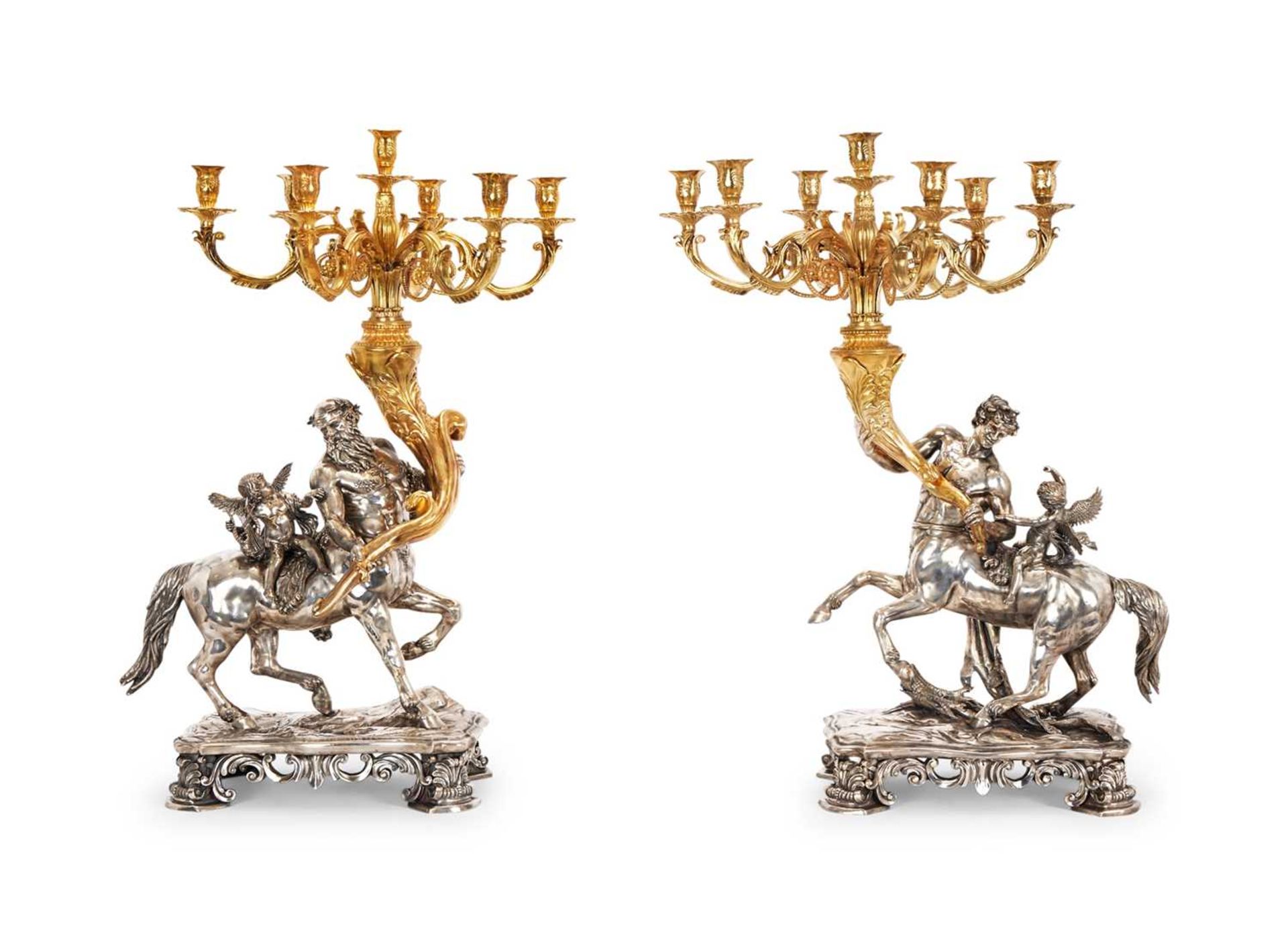 A MASSIVE PAIR OF SILVER AND SILVER GILT ITALIAN BAROQUE STYLE CANDELABRA