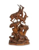 A LARGE LATE 19TH CENTURY BLACK FOREST CARVED LINDENWOOD GROUP OF IBEXES