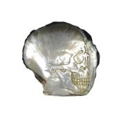 A BLACK-LIP OYSTER MOTHER OF PEARL SHELL CARVED WITH A HUMAN SKULL