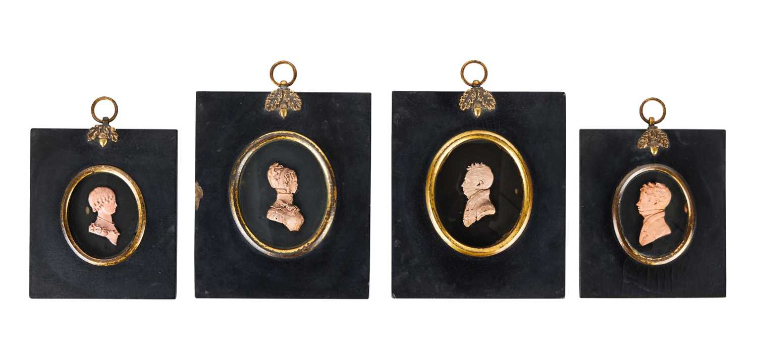 FOUR EARLY 19TH CENTURY PASTE GLASS MINIATURE PORTRAITS IN THE MANNER OF TASSIE