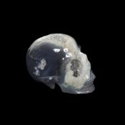 A SOLID SPECIMEN OF CHALCEDONY CARVED IN THE FORM OF A HUMAN SKULL