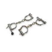 TWO PAIRS OF CAST IRON CONVICT HANDCUFFS