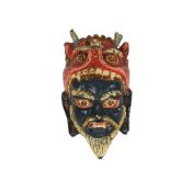 AN ANTIQUE PAINTED BARK TRIBAL MASK FROM NEPAL
