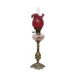 A 19TH CENTURY OIL LAMP WITH RUBY GLASS SHADE