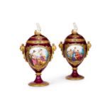 A PAIR OF LATE 19TH CENTURY VIENNA PORCELAIN URNS AND COVERS