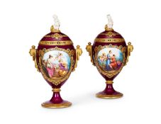 A PAIR OF LATE 19TH CENTURY VIENNA PORCELAIN URNS AND COVERS