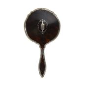 AN EARLY 20TH CENTURY SILVER MOUNTED TORTOISESHELL HAND MIRROR