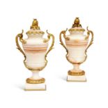 A PAIR OF 19TH CENTURY FRENCH ALGERIAN ONYX AND ORMOLU MOUNTED URNS AND COVERS