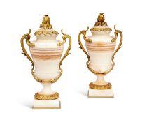 A PAIR OF 19TH CENTURY FRENCH ALGERIAN ONYX AND ORMOLU MOUNTED URNS AND COVERS