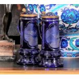 A FINE PAIR OF 19TH CENTURY BOHEMIAN BLUE OVERLAY CUT AND ENGRAVED GLASS TANKARDS