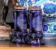 A FINE PAIR OF 19TH CENTURY BOHEMIAN BLUE OVERLAY CUT AND ENGRAVED GLASS TANKARDS