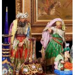 A PAIR OF MID 19TH CENTURY PARIS PORCELAIN PERFUME BOTTLES IN THE FORM OF A SULTAN AND HIS ATTENDANT