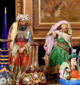 A PAIR OF MID 19TH CENTURY PARIS PORCELAIN PERFUME BOTTLES IN THE FORM OF A SULTAN AND HIS ATTENDANT
