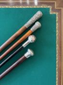 FOUR LATE 19TH / EARLY 20TH CENTURY WALKING CANES INCLUDING A VICTORIAN EXAMPLE WITH SILVER POMMEL