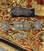 FOUR SETS OF SILVER AND SILVER PLATED BELT BUCKLES