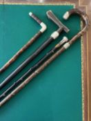 FOUR LATE 19TH / EARLY 20TH CENTURY SILVER MOUNTED WALKING CANES