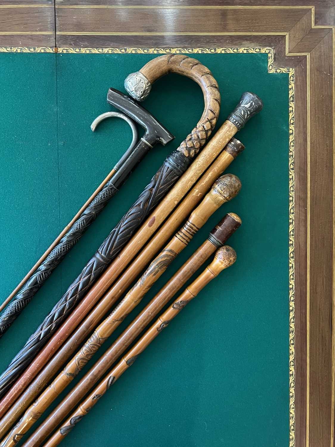 A GROUP OF EIGHT 19TH CENTURY WALKING CANES AND STICKS