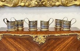 A SET OF LATE 19TH CENTURY RUSSIAN SILVER, PARCEL GILT AND NIELLO TEA GLASS HOLDERS