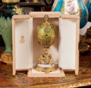 A FABERGE STYLE DIAMOND ENCRUSTED, GUILLOCHE ENAMEL AND SILVER GILT SURPRISE EGG