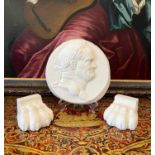 A PLASTER RELIEF OF EMPEROR NERO TOGETHER WITH TWO PLASTER LIONS PAWS