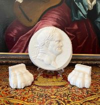 A PLASTER RELIEF OF EMPEROR NERO TOGETHER WITH TWO PLASTER LIONS PAWS
