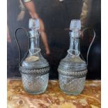 A PAIR OF PRESSED GLASS CLARET JUGS