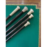 FIVE LATE 19TH / EARLY 20TH CENTURY EBONY AND EBONISED WALKING CANES