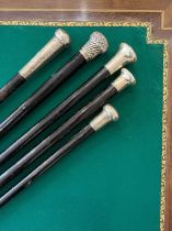FIVE LATE 19TH / EARLY 20TH CENTURY EBONY AND EBONISED WALKING CANES