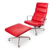 AN EAMES RED LEATHER SOFT PAD CHAIR WITH MATCHING STOOL