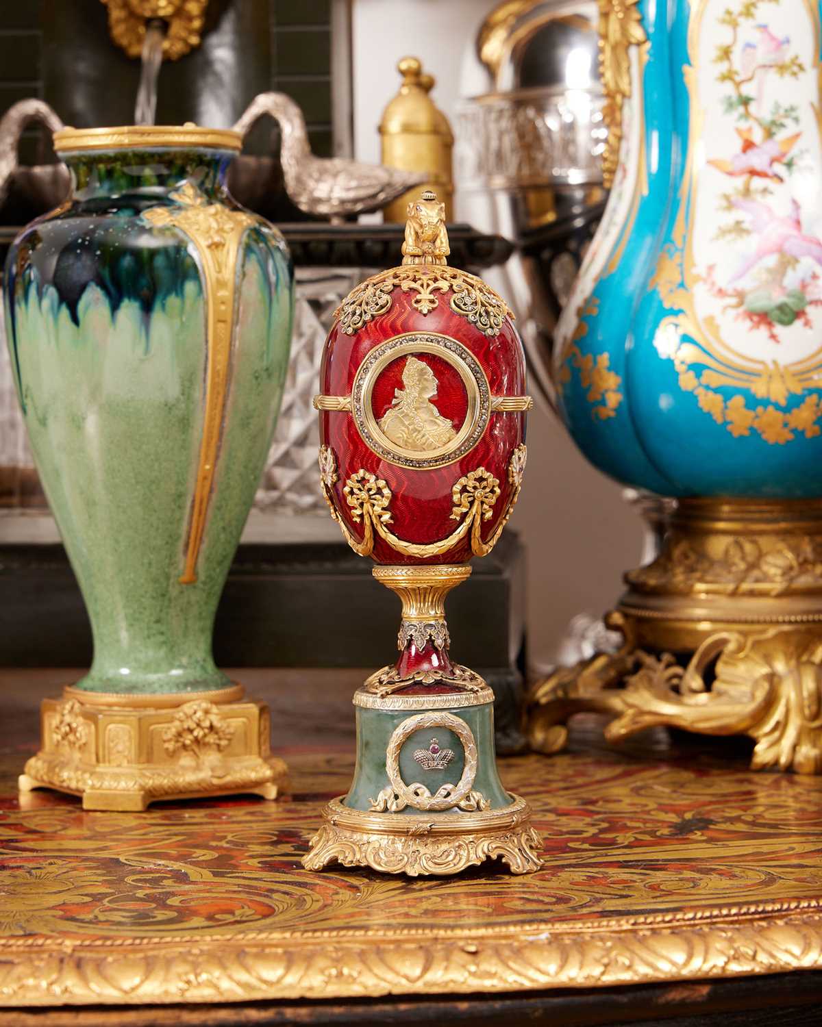 A FABERGE STYLE DIAMOND ENCRUSTED, GUILLOCHE ENAMEL AND SILVER GILT EGG