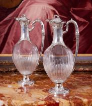 A FINE PAIR OF 19TH CENTURY FRENCH SILVER AND GLASS CLARET JUGS