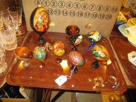 Nine Russian Lacquer Eggs and Various Stands
