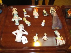 Eleven Porcelain Pin Cushion Ladies and a Brush
