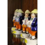 FOUR 19TH CENTURY PEARLWARE FIGURATIVE PEPPER POTS