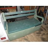 A PLASTIC GARDEN BENCH WITH LIFT-UP LID FOR STORAGE