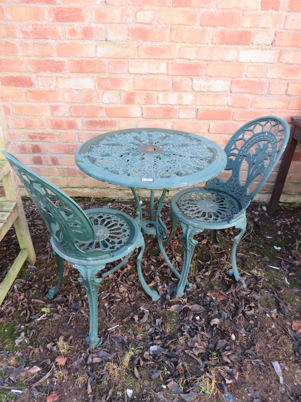 A METAL PATIO TABLE AND TWO CHAIRS