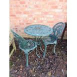 A METAL PATIO TABLE AND TWO CHAIRS