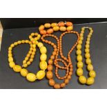 A COLLECTION OF AMBER AND LUCITE VINTAGE BEADS, comprising three necklaces and one bracelet